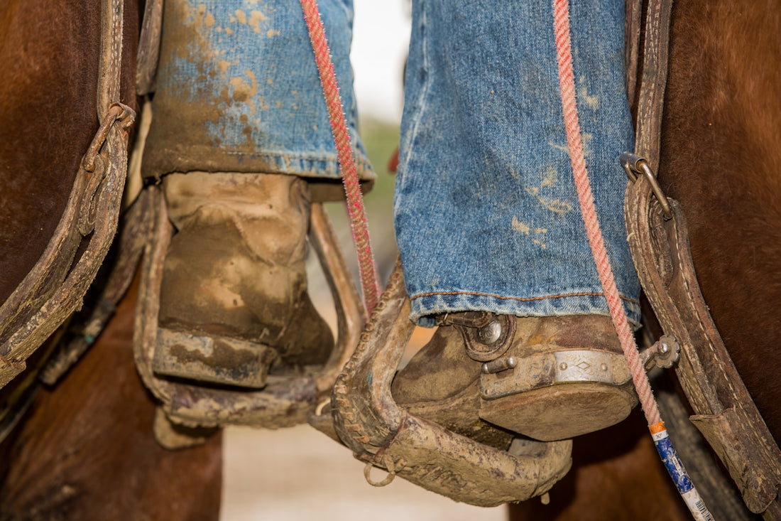 person in blue denim jeans and brown hiking boots