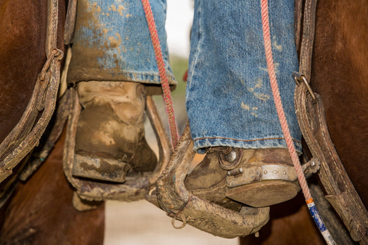 person in blue denim jeans and brown hiking boots