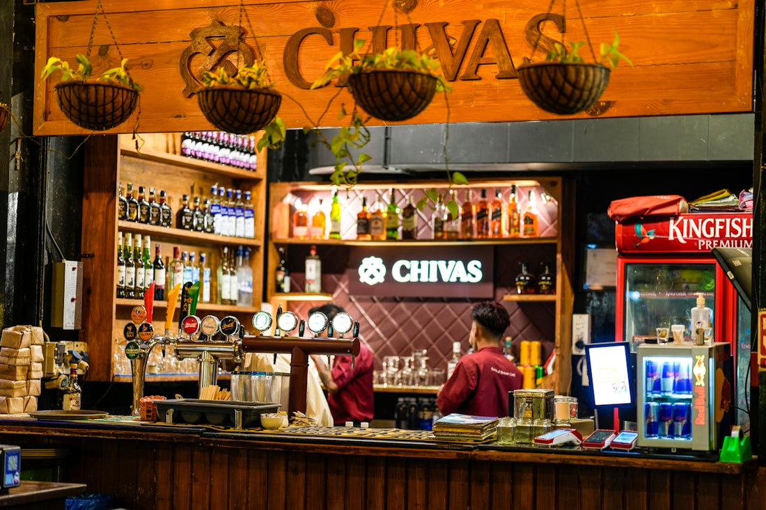 A bar with bottles of alcohol and a bartender