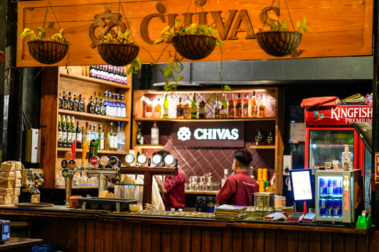 A bar with bottles of alcohol and a bartender